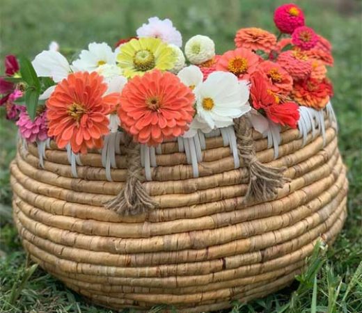 a bamboo basket filled with Zinnia flowers